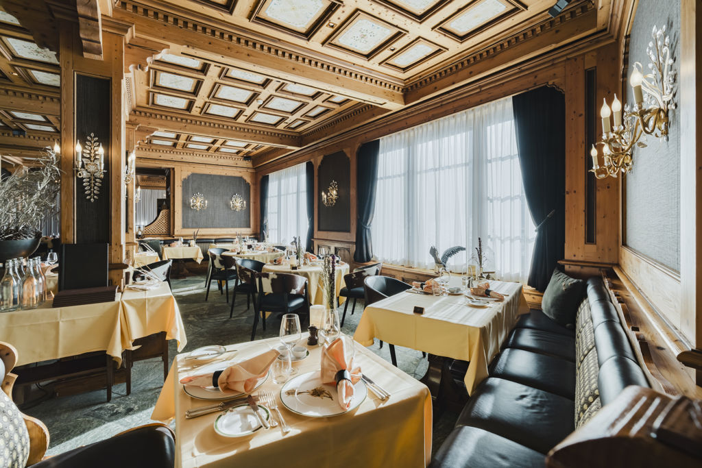 Salle en boiseries du Restaurant Alexandre en hiver au Riffelalp Resort 2222m à Zermatt, hôtel de luxe 5 étoiles dans les Alpes suisses mêlant romantisme alpin, service attentionné et gastronomie inspirée des montagnes et de la Méditerranée.